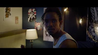 a man is standing in a room with lights on