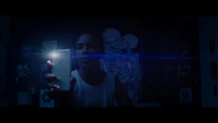 a man takes a picture with his cell phone in the dark
