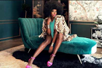 a woman in a leopard coat sitting on a turquoise chair