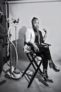 a black and white photo of a woman sitting in a chair