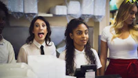 a group of women standing in front of a counter