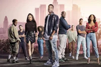 a group of people standing in front of a city